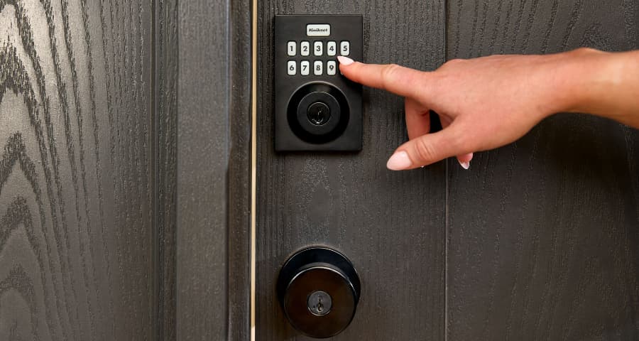 Person pressing the keypad of a Vivint smart lock